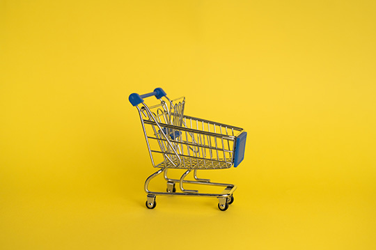 toy shopping cart on yellow background